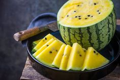 sliced watermelon in a bowl with knife