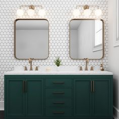 a bathroom with two sinks and mirrors on the wall