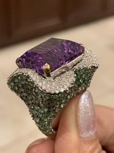 Diamond Amethyst Tsavorite Ring, Amethyst Cocktail ring, Tsavorite Ring, diamond Amethyst Jewelry, Diamond Tsavorite Jewelry Gross Weight 17.74gm 18k Gold- .6gm Single Cut Diamond- 1.45 carat Silver- 10.44 gm Amethyst Tsavorite- amethyst22.37carats 15 by 20 mm green Tsavorite9.68 carats ring face 22 by 26 mm Current size in stock 7.5US but we can make in any size This Gorgeous Amethyst Tsavorite Cocktail ring is Classic and High Fashion. It is crafted with 18k White gold and Silver to reduce cos Luxury Tsavorite Gemstones For Anniversary, Luxury Multi-stone Emerald Ring As Gift, Luxury Multi-stone Emerald Ring For Gift, Luxury Amethyst Diamond Ring For Gift, Luxury Tsavorite Ring With Gemstone Accents, Luxury Tsavorite Jewelry With Gemstone Accents, Luxury Tsavorite Rings With Brilliant Cut, Luxury Tsavorite Diamond Ring For Anniversary, Luxury Amethyst Ring With Emerald Cut Diamond