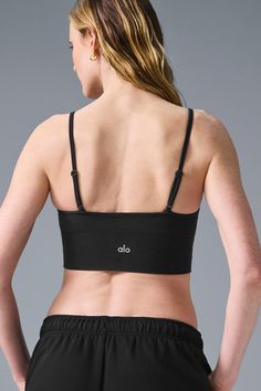 The super-soft, low-impact Delight Bralette is an on-the-go staple with a forward low V-neck, delicate, adjustable straps and snug, longline silhouette. A ribbed underband provides extra compression & support. Wear it to the studio, then layer it under a tank post-practice. Soft & seamless cotton Adjustable straps & longline fit Light, everyday support for studio & street Designed & uniquely fit to flatter every size Wear-tested by our in-house team for the perfect fit Woman Back, Street Design, Black Bralette, Back Women, Alo Yoga, Long A Line, Bra Tops, New Woman, The Studio