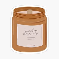 a jar filled with honey sitting on top of a white table next to a sticker