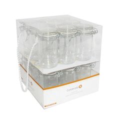 six empty glass jars in a clear box