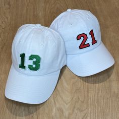 The Kids Biggest Fan Hat is the perfect addition to any game day outfit for your littles! Get it customized with your team's colors and your player's number. THIS IS A YOUTH SIZE HAT. If you are looking for the adult version and don't see it in the shop feel free to message me.  HOW TO ORDER: Pick a color for your number AND a color for the number outline. Choose a white or black felt backing (this is not the hat color, it is the backing the number is embroidered onto for the patch). Then list what number you would like on your hat.  See picture with colors for the corresponding numbers. EX. - 16 for number, 12 for outline. OR 9 for number and outline. Please let me know if you have any questions and I will help make sure you get what you are looking for, I am always here to help! The numb White Hats With Letter Patch, White Fitted Hat For Baseball Season Game Day, White Fitted Hat For Baseball Game Day, White Sports Fan Hat One Size Fits Most, White Sports Fan Hat, One Size Fits Most, White Baseball Cap For Game Day, Customizable White Hats For Fan Gear, White Sports Fan Hat With Letter Print, White Baseball Cap With Curved Brim For Game Day