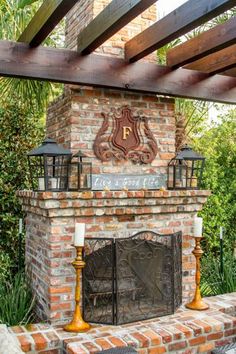 an outdoor fireplace with candles on it