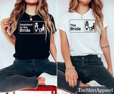 two women wearing t - shirts that say, the bride and the attendant are sitting on stools