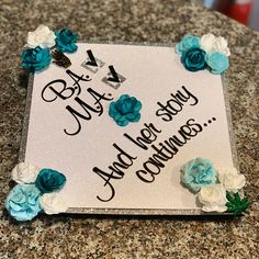 a white sign with blue and white flowers on it