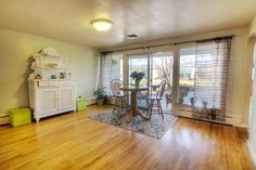 a living room with hard wood floors and sliding glass doors