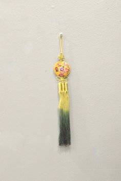 This is a beautiful Korean Norigae or embroidered tassel, which is Korean accessory that is hung from a women's coat strings or skirt. The norigae's function as a decorative pendant is both a good-luck charm hoped to bring something such as eternal youth, wealth or many sons (depending on its shape), as well as a fashion accessory. Usually, the Norigae from the parents' or in-laws' home was passed down to descendants. These decorative tassels come in a variety of shapes, colors and sizes and are dervi from nature or everyday life. A wonderful item to adorn your home or add to your collection. Shows Natural Age and Wear 13.5 Inches Long 16.5 Inches Long from Loop to Bottom AT BACARA WE STAND BEHIND ALL OF OUR MERCHANDISE. FULL MONEY BACK GUARANTEE WILL BE PROVIDED FOR DISSATISFIED CUSTOMERS Decorative Tassels, Korean Accessories, Eternal Youth, Silk Accessories, Luck Charm, Handmade Clothing, Luck Charms, Women's Costumes, Descendants