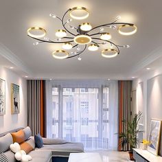 a living room filled with lots of furniture and lights on the ceiling over a white coffee table