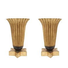 a pair of vases sitting on top of wooden bases