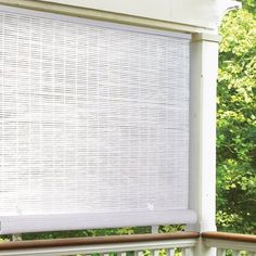 a white window covering on the outside of a house