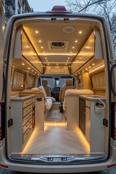 the interior of a van with its doors open and lights on in front of it