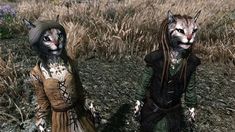 two weird looking cats standing next to each other in a field with grass and flowers