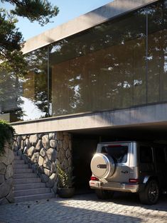 a jeep parked in front of a building with stone steps leading up to the entrance