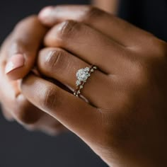 a woman's hand with a diamond ring on it