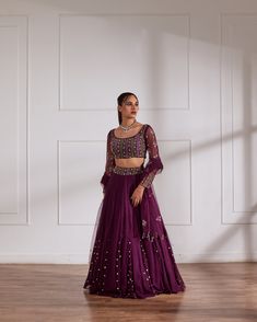 Wine fully embroidered choli with net sleeves paired with inserted kali lehenga and wine net dupatta. No. of pieces in a set: 3 Color: Wine Fabric Composition: Opada silk, net georegette Lining Material: Shantoon Closure used: Side zip in both choli and lehenga Dress Length : Full Silhouette: Kalidaar Neck type : Round neckline Sleeve Length: full Sleeves Waistline: High waist Prints/ Pattterns : Plain Delivery Time: 20-25 days Long Sleeve Purple Choli With Pallu, Purple Long Sleeve Lehenga For Diwali, Purple Long Sleeve Choli With Pallu, Bollywood Style Purple Choli With Long Sleeves, Purple Party Wear Lehenga For Eid, Purple Long Sleeve Lehenga For Eid, Purple Long Sleeve Bollywood Choli, Fitted Net Choli With Cutdana, Red Lehenga Choli