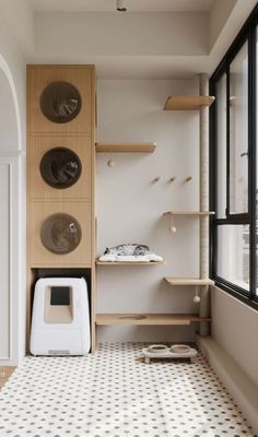 a kitchen with black and white tile flooring next to a wall filled with shelves