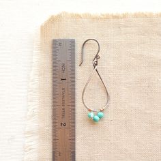 Delicate forged teardrop shaped hoops are adorned with tiny turquoise wrapped in gold wire. I love the contrast of metals and the elegant form of these earrings. Measure 1 7/8". Handmade shepherd hook earwires. 14k gold fill and sterling silver, which has been oxidized and hand polished for an antique finish. About turquoise: The name turquoise means "Turkish stone" because the trade route that brought it to Europe came via Turkey. Turquoise is a non-translucent stone of which the most valuable Teardrop Hoop Earrings, Turquoise Hoop Earrings, Turquoise Hoops, Brown Jewelry, Gold Wire, Antique Finish, Etsy Shipping, Delicate Bracelet, Turquoise Bracelet