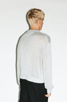 A lightweight layer constructed in an open-weave, cool-touch viscose. Tailored for an oversized, relaxed fit with dropped shoulders, exaggerated ribbed edges and extra long sleeves. A 90's minimalist silhouette with a gritty, semi-sheer twist. Versatile Spring Sweater With Ribbed Cuffs, Spring Textured Knit Sweater In Relaxed Fit, Relaxed Fit Spring Sweater For Layering, Modern Spring Sweater With Ribbed Cuffs, Modern Sweater With Ribbed Cuffs, Oversized Sweater For Spring Streetwear, Modern Knit Sweater For Spring, Oversized Pointelle Knit Tops For Layering, Casual Textured Knit Sweater For Daywear