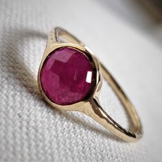 This stunning ring is set in 14k Solid Yellow Gold with Natural Ruby with utmost precision. It is a unique statement gemstone ring for nearly every occasion and is completely hassle-free jewelry. ITEM DETAILS: * GEM: Ruby * GEM SIZE: 7mm * GEM SHAPE: Round * SIDE GEM: Pink Tourmaline * GEM SIZE: 3mm (12 pcs) * GEM SHAPE: ROUND * Total Gem weight: 1.65 carats * Gold Purity: 14KT  * Gold Weight: 1.31 gram * Total Weight of the Ring: 1.64 gram The Gold purity is guaranteed and it comes with an auth 14k Gold Ruby Ring, Gold Ruby Ring, Gem Ruby, July Birthstone Ring, Natural Ruby Ring, Ruby Ring Gold, Handmade Jewelry Box, Ring Bezel, Bezel Ring