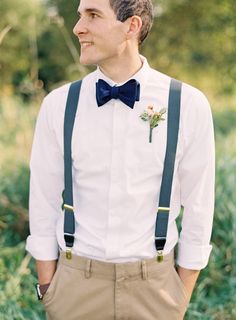 a man wearing suspenders and a bow tie