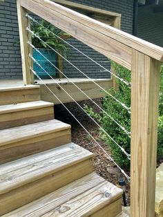 a close up of a wooden stair case with metal handrails on the side