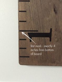 a wooden ruler with the words, first mark exactly 4 inches from bottom of board