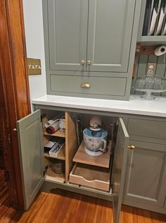 an open cabinet in the corner of a kitchen