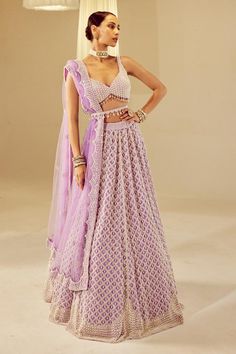 Lilac attached cancan lehenga with pearl drop embellishments. Comes with heavily embellished sweetheart neck padded blouse and dupatta.
Components: 3
Pattern: Embellished
Type Of Work: Pearls
Neckline: Sweetheart
Sleeve Type: Sleeveless
Fabric: Blouse and Lehenga: Georgette, Dupatta: Net, Lining: Silk Blend
Color: Purple
Other Details: 
Tassel hem blouse
Lehenga length: 46 inches
Note:
Belt worn by the model and the lehenga set worn by the other model on the back is not for sale.
Kindly contact Sweetheart Neck Blouse, Vani Vats, Cancan Lehenga, Blouse Lehenga, Tassel Blouse, Georgette Lehenga, Georgette Dupatta, Padded Blouse, Lehenga Blouse