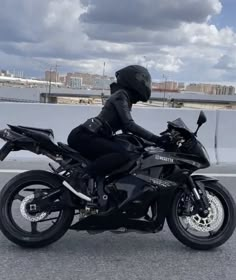 a person riding on the back of a black motorcycle