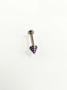 a purple and white striped cone shaped nose piercing