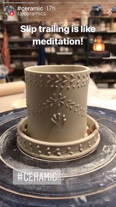 a clay pot sitting on top of a blue plate with words above it that read ceramic ceramics