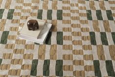 a book sitting on top of a table next to a brown and white elephant figurine