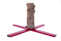 a piece of wood sitting on top of two red sticks