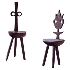 two small stools made out of wood and metal, each with a unique design