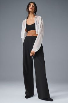 A shorter version of our best-selling Pursuit Trousers, this modern fit is the ultimate closet staple. They have a high-rise waistband (flat in front and stretchy in back), tailored details (belt loops and pleats), and a relaxed, wide-leg fit. Plus, they’re made from a lightweight, stretch-infused fabric that looks sleek and feels totally comfortable. You'll go straight from work to your weekend plans with just a change of shoes. Versatile Alo Yoga Bottoms, Elegant High Rise Bottoms For Business Casual, Elegant High-rise Bottoms For Business Casual, Chic Bottoms With Elastic Waistband And Minimal Stretch, Elegant High-rise Wide Leg Pants For Workwear, Black Cropped Elastane Bottoms, Chic Cropped Pants For Evening, Fitted Cropped Pantsuit For Formal Events, Classic Pantsuit For Night Out