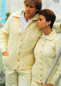 a man and woman in sweaters standing next to each other