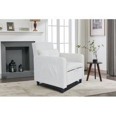 a white chair sitting in front of a fireplace