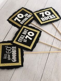 four black and gold stickers with the words 70 rocks on them sitting next to each other