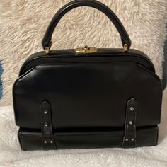 This Is Stunning Elegant And Unique Doctor’s Bag,Has Aged But Definitely A Beauty,Has Sign Of Used Inside We’re You Can See Some Dirt/Dust/Stain But Overall In Good Condition,Comes With The Key That Has A Tear On The Key Holder. Designer Black Handheld Box Bag, Black Satchel With Hasp Closure For Shopping, Black Box Bag With Hasp Closure For Shopping, Designer Black Box Bag For Office, Luxury Black Satchel With Hasp Closure, Vintage Black Shoulder Bag With Hasp Closure, Retro Black Shoulder Bag With Top Handle, Retro Black Top Handle Shoulder Bag, Black Retro Top Handle Shoulder Bag