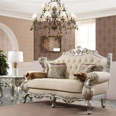 a fancy living room with white furniture and chandelier