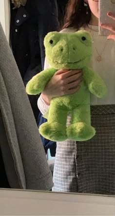 a green spring frog from build-a-bear being held by a girl with brown hair, in front of a mirror Toy Pictures, Green Frog, Cute Stuffed Animals, Fleetwood Mac, Build A Bear, Cute Plush