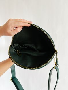 Our newest any-way, hands-free pack now in vegan leather! Wear this stunning Evergreen bag cross body across your chest or to your hips, around your waist as a belt bag, or over your shoulder as your new on-the-go purse. The options are endless no matter what size you are or how you want to wear it. The strap can easily clip or unclip for adjusting and lengthens up to 46 inches. Add a fabric strap for a more casual look! dimensions:9.25" across top (folded)8" across bottom1.5" deep6.5" high (fol Green Shoulder Belt Bag With Zipper Closure, Everyday Green Belt Bag With Zipper Closure, Green Everyday Belt Bag With Zipper, Green Belt Bag With Zipper Closure For Everyday Use, Versatile Green Belt Bag, Green Crossbody Belt Bag For Everyday Use, Green Crossbody Belt Bag With Detachable Strap, Green Belt Bag With Detachable Strap, Versatile Green Belt Bag With Removable Pouch