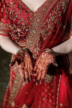 a woman in a red dress holding her hands together