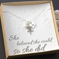 a box with a necklace in it that says she believed she could so she did