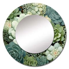 a round mirror with succulents and flowers on it's side, in front of a white background