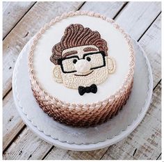 a cake decorated with an image of a man's face and glasses on it