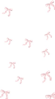 pink bows flying in the air on a white background