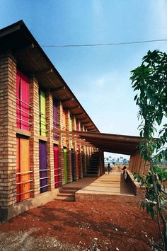 the building is made out of bricks and has multicolored doors