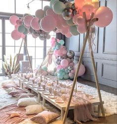 a long table with balloons and plates on it